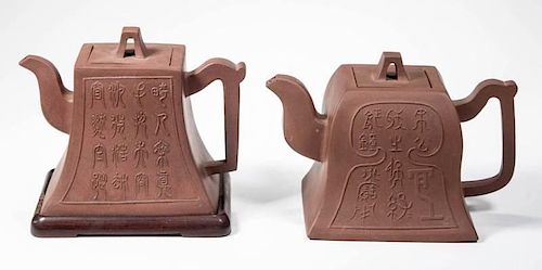CHINESE YIXING POTTERY TEAPOTS AND A STAND, LOT OF THREE