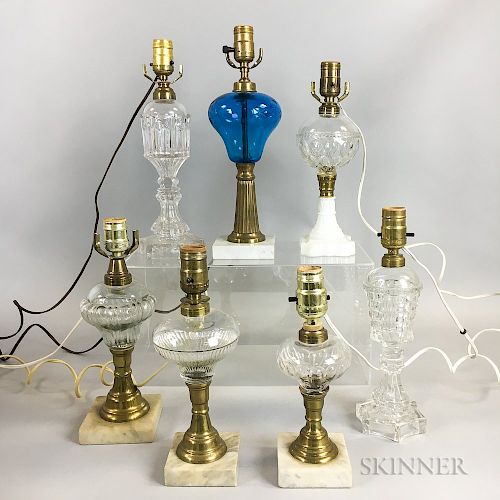 Seven Mostly Colorless Pressed Glass Fluid Lamps