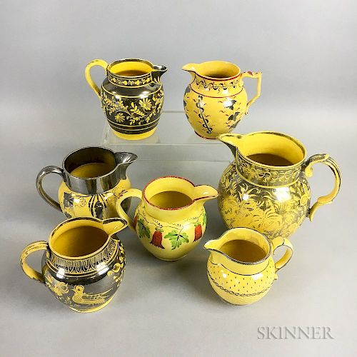 Seven Staffordshire Yellow-glazed Ceramic Jugs
