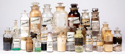 Group of colorless labeled apothecary bottles