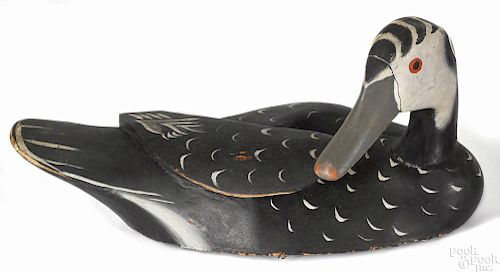 Carved and painted preening duck decoy, 20th c., with a balsa body, 11'' l.