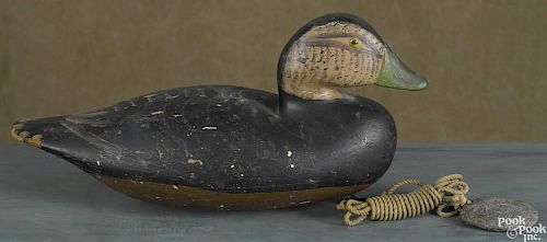 Carved and painted black duck decoy, mid 20th c., 13'' l.