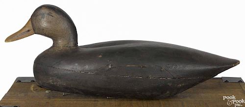 New Jersey carved and painted black duck decoy, mid 20th c., signed Jake Barrett, 17'' l.