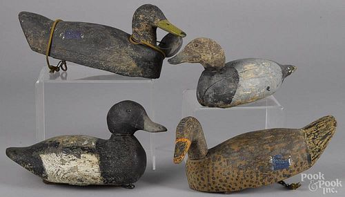 Four carved and painted duck decoys, mid 20th c., to include a bluebill, attributed to Victor