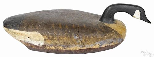 Carved and painted swimming Canada goose decoy, mid 20th c., having a cork over wood body