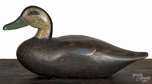 Illinois River carved and painted black duck decoy, mid 20th c., 15'' l.
