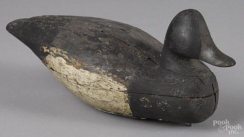 Two carved and painted black duck decoys, early 20th c., 17'' l. and 14 1/4'' l.