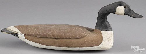 Carved and painted swimming Canada goose decoy, mid 20th c., with relief carved wings, 27 1/2'' l.