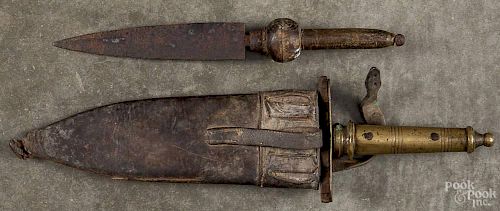 Two daggers, 19th c., to include a Middle Eastern example with a brass handle and leather sheath