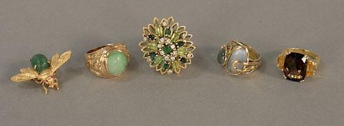 Five piece gold lot to include 14K cocktail ring set with green stones and diamonds, 14K ring set with green harstone, 14K bug pin s...