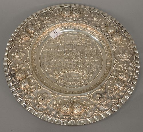 Continental silver round tray with embossed Hebrew writing and embossed flowers, dia. 17in, troy ounces: 33.5. Provenance: An Estate...