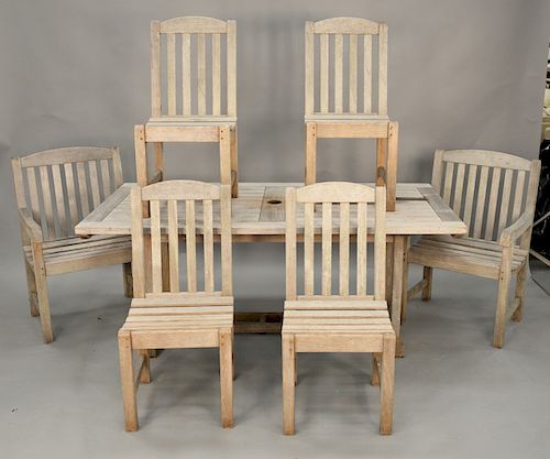 Eight piece outdoor teak set to include Smith and Hawken rectangle table with round end extensions (17 1/2 in. each), 2 armchairs and 4 side chairs an