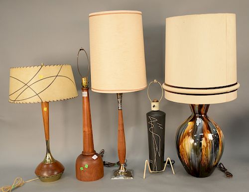 Five piece mid century lamp lot to include three teak lamps along with one ceramic and one porcelain, ht. 26" to 42".