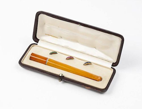 An Art Deco amber and gem-set cigarette holder
