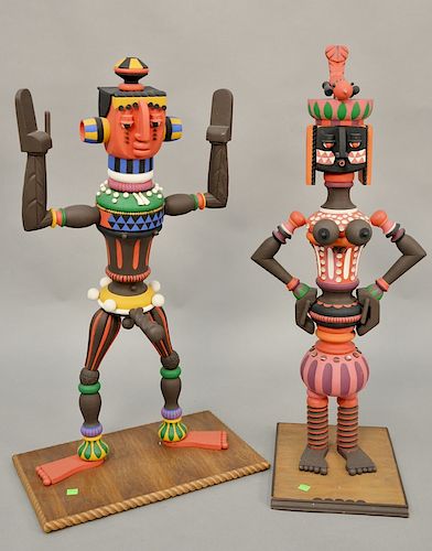 Jacqueline Fogel (20th century), carved painted wood, pair of figures standing on wood base, signed Jacqueline Fogel 1977, ht. 33 in, 34 in.