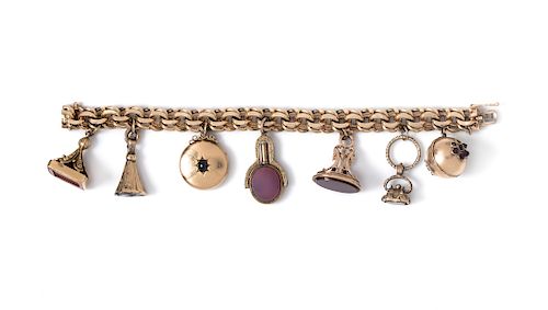 A 14 Karat Yellow Gold Bracelet with Seven Attached Fobs and Charms,