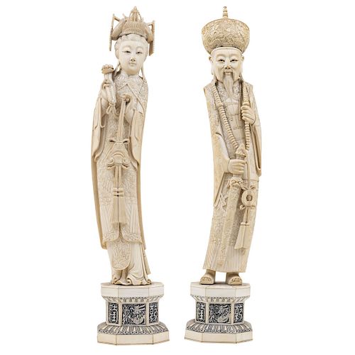 EMPEROR AND EMPRESS. CHINA, 20TH CENTURY.  A pair of carved ivory models with ink details.