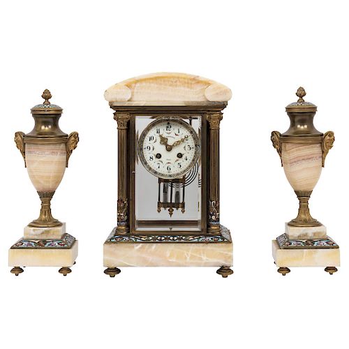 CLOCK GARNITURE. FRANCE, CIRCA 1900. Empire Style. Gilt-bronze, brass, cloisonné enamel and marble. With clock and a pair of matching urnes.