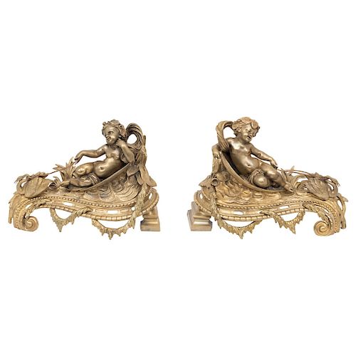 A PAIR OF CHENETS. FRANCE, 19TH CENTURY. EMPIRE style. Gilt-bronze. In the form of infants and swans.