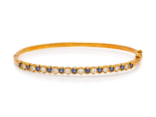 An 18 Karat Yellow Gold, Diamond and Sapphire Bangle Bracelet,