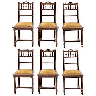 Lote de 6 sillas. Francia. SXX. Estilo Enrique II. En talla de madera de nogal. Con respaldos semiabiertos y asientos en tapicería.