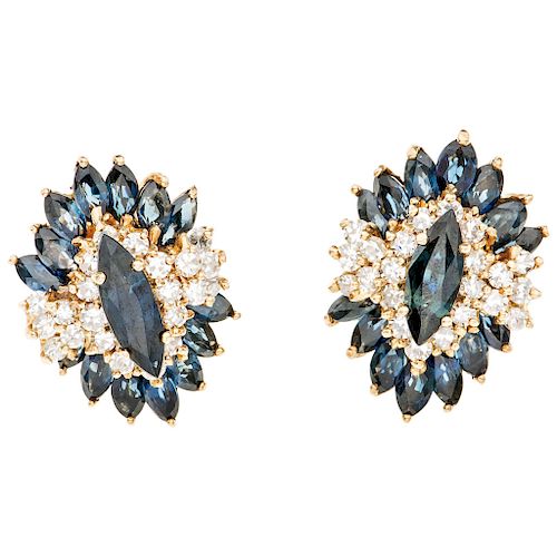 A sapphire and diamond 14K yellow gold pair of earrings.