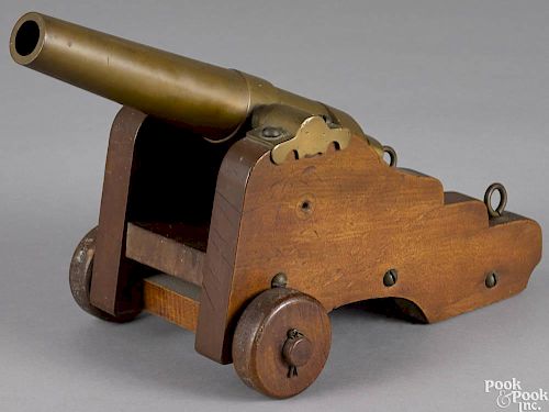 Brass signal cannon, 19th c., with a walnut carriage, barrel - 10'' l.