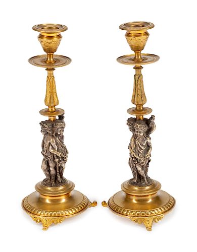 A Pair of French Gilt and Silvered Bronze Figural Candlesticks