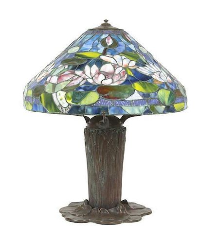 A Leaded Glass Lamp, after Tiffany Studios, Height 23 1/2 inches x diameter of shade 19 1/2 inches.