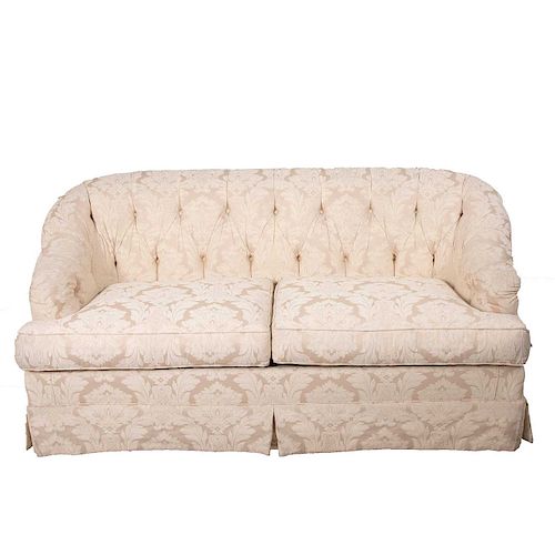 Love seat. Siglo XX. Estructura de madera con respaldos capitonados y asientos acojinados en tapicería textil blanca floral.