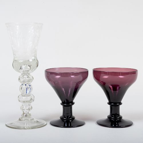 Two Amethyst Glass Rummers with an Etched Glass Goblet