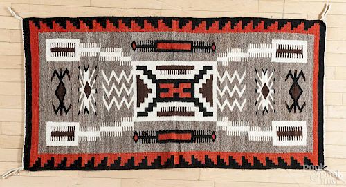 Navajo weaving with geometric patterns on a gray field, 30'' x 56''.