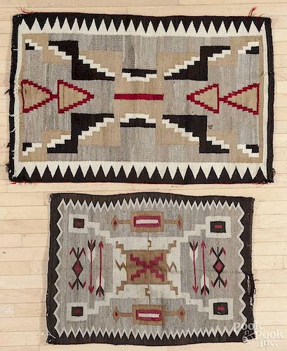Two Navajo weavings with geometric patterns and serrated borders, 33'' x 50'' and 27'' x 38''.