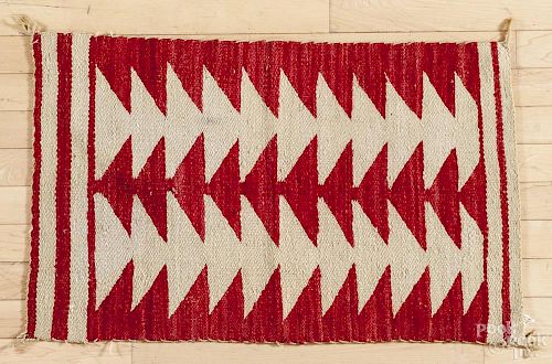 Navajo rug with a repeating triangle pattern, 20'' x 32''.