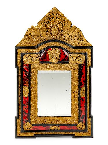 A Flemish Baroque Style Repouseed Brass and Ebony Mirror