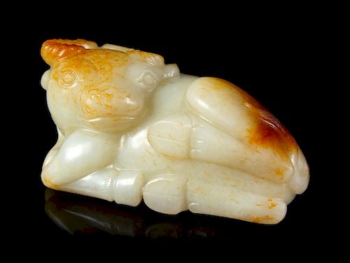 A Russet and White Jade Figure of a Buffalo
Height 2 1/4 in., 6 cm. 