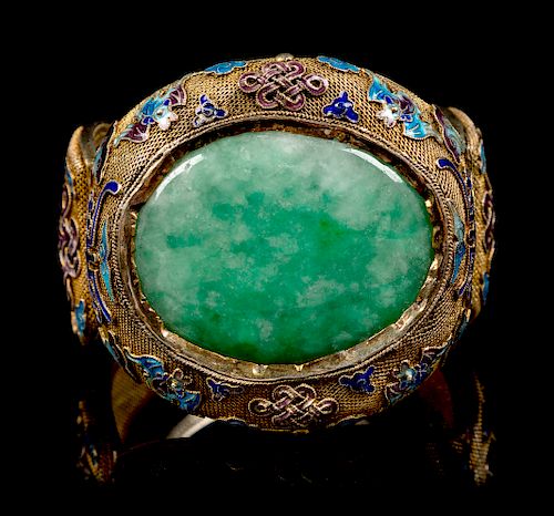 An Apple Green and Pale Celadon Jadeite Inset and Enamel Inlaid Silver-Gilt Filigree Bracelet
Width 2 7/8 in., 7 cm. 