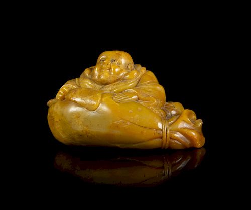A Carved Soapstone Figure of a Laughing Buddha
Length 4 in., 10 cm. 
