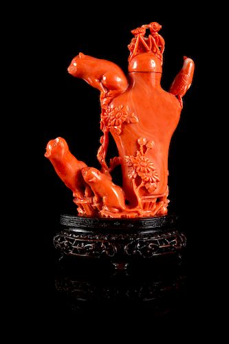 A Carved Red Coral Snuff Bottle Height overall 4 1/4 in., 10.8 cm; height without stopper 3 1/2 in., 9 cm.