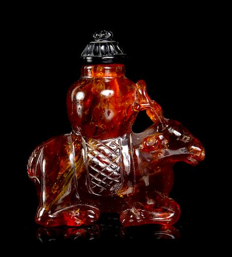 A Carved Amber 
Deer
 Snuff Bottle
Height 1 7/8 in., 5 cm. 