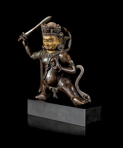A Sino-Tibetan Parcel-Gilt Bronze Figure of Jambhala
Figure height 8 1/2 in., 22 cm.