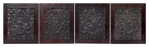 A Set of Four Chinese Zitan Wood 'Dragon' Panels
Each: height 13 in., 33 cm. 