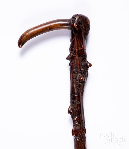 Carved faces walking stick