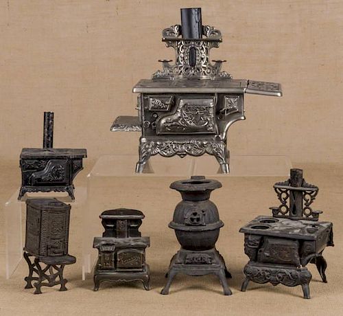 Six toy stoves, to include a cast iron, nickel, a