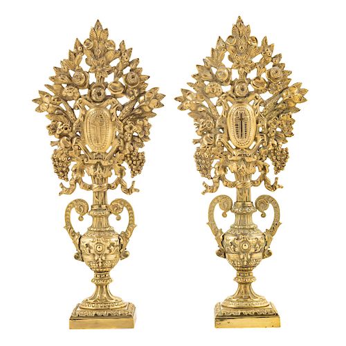 A PAIR OF CANDLESTICKS. MEXICO, BEGINNIG OF THE 20TH CENTURY. Golden embossed bronze. Decored with flower motifs, vines and crucifixes.  