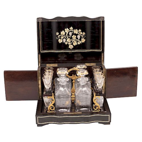 DECANTER BOX. FRANCE, 19TH CENTURY. Napoleon III Style. Ebonized wood with brass details. 4 decanters and 16 crystal glasses. 
