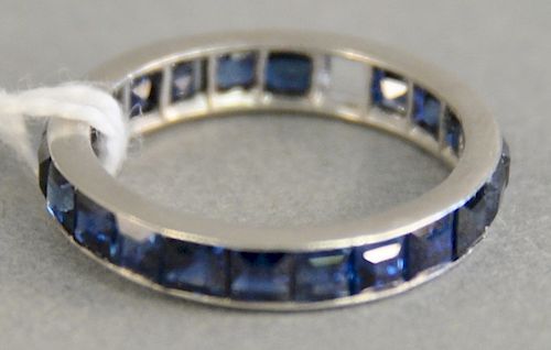 Platinum and sapphire ring with eternity band with channel set square sapphires, one sapphire missing, size 4 1/2, total weight: 2.7g.