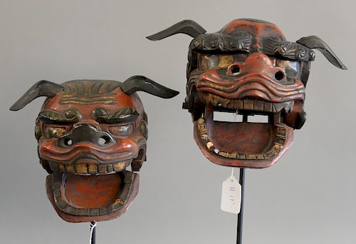 Pair of Japanese red and black lacquer shi shi masks each with hinged lower jaw on steel stand. total ht. 14 in.