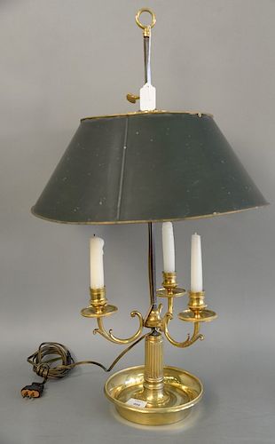 A Louis XVI style brass three light bouillotte lamp with adjustable tole shade, fluted stem issuing scrolling foliate arms on a dish...