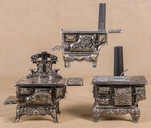 Three cast iron and nickel toy stoves, to include